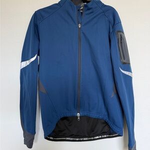 REI navy blue men's performance softshell jacket with reflective accents